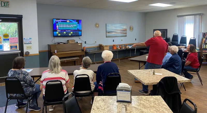 people playing Wheel of Fortune game