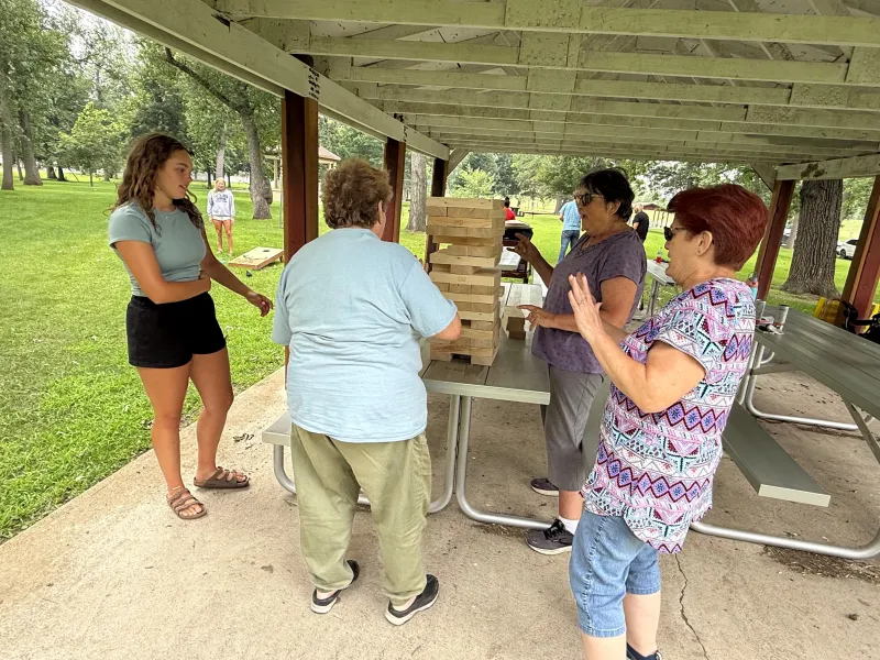 people playing Jenga outdoors