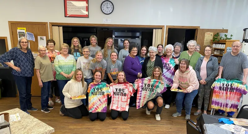 people posing with "you matter" shirts