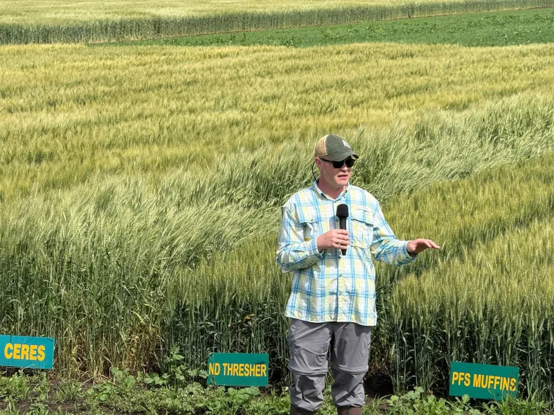 man giving a presentation in a field