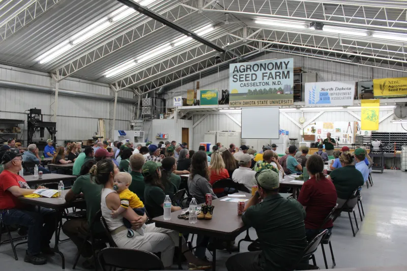 people in a pole barn listening to a speaker