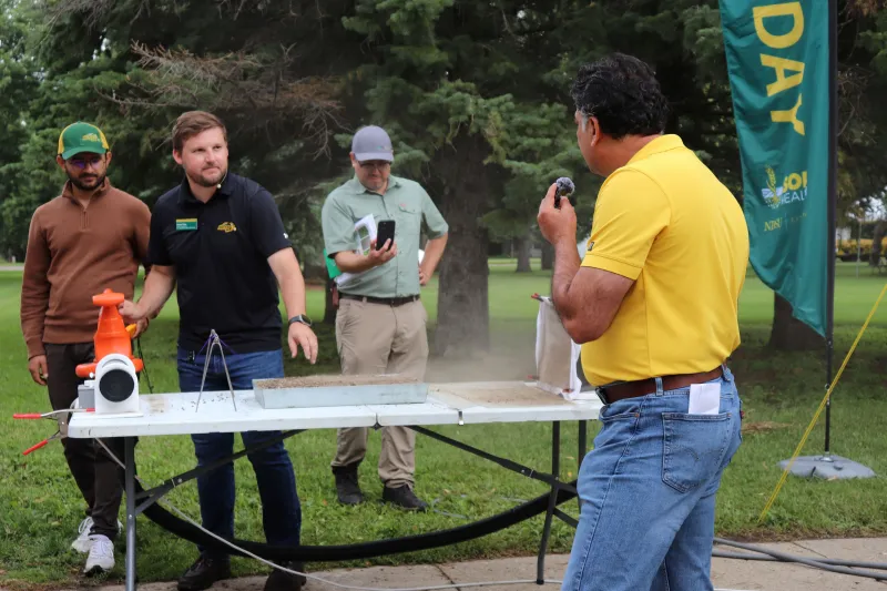 Field Day participants view soil health demonstration.