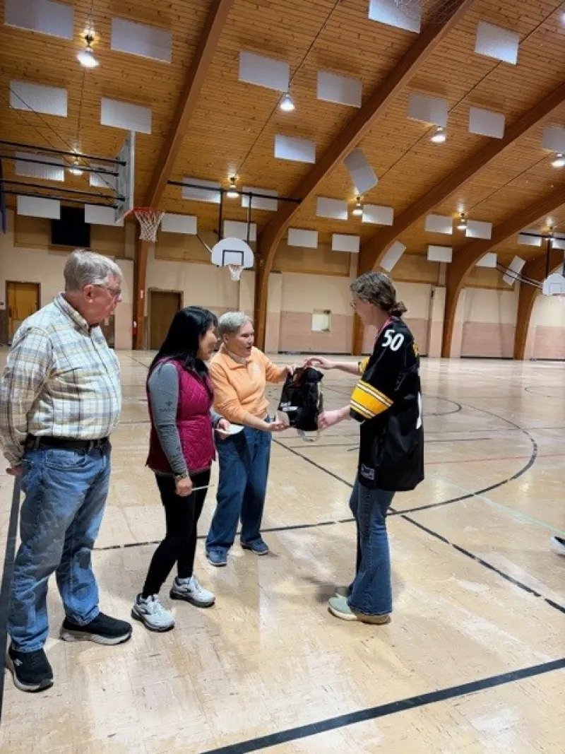 a senior citizen presented a prize for attending walking sessions