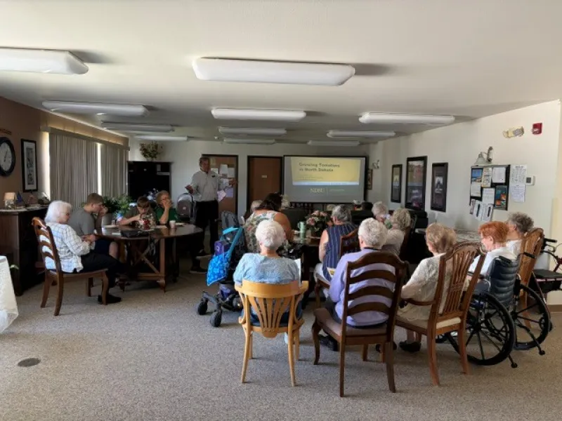 A man presenting to senior citizens