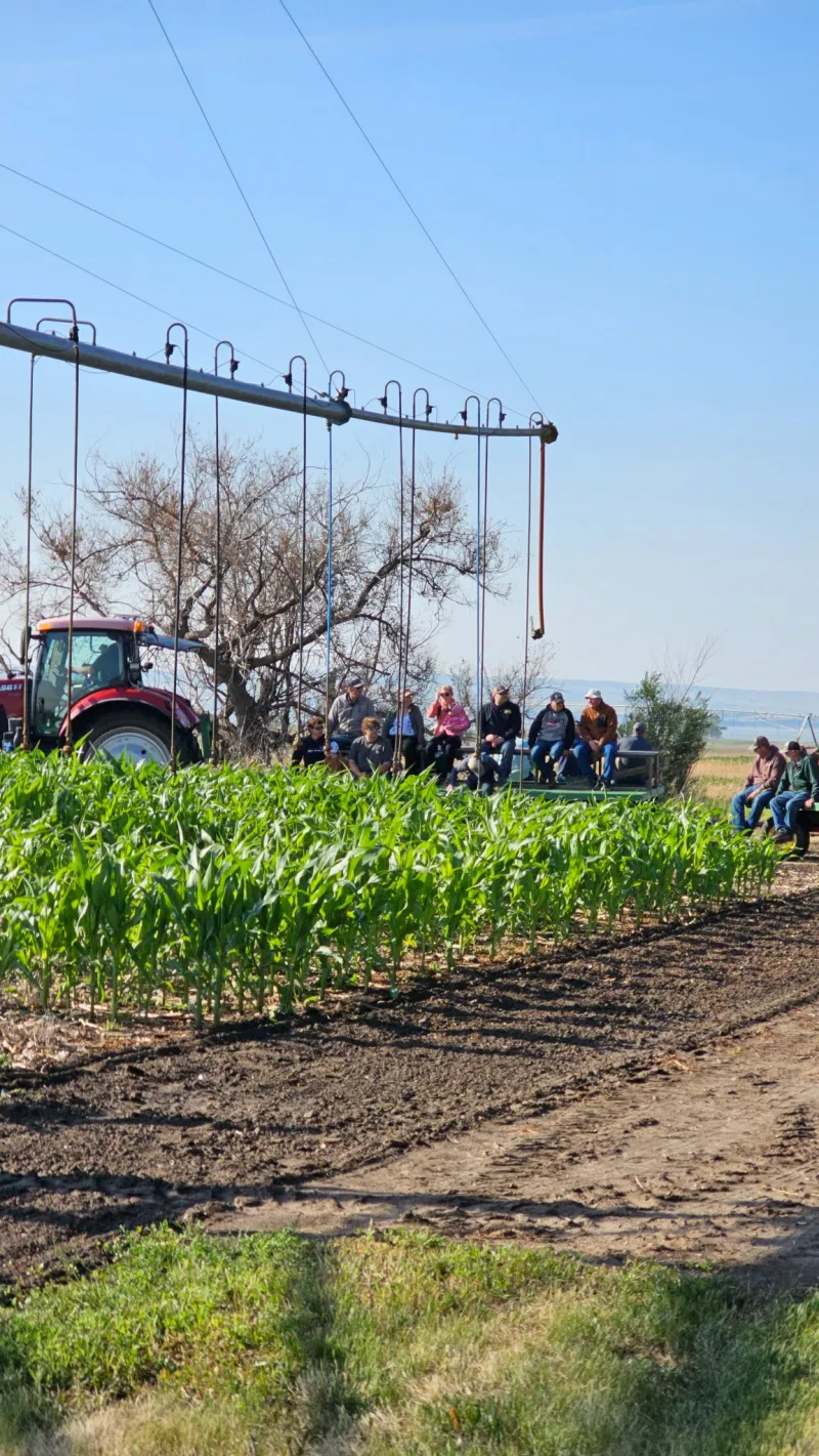 irrigation machine in a crop field demo with tractor nearby