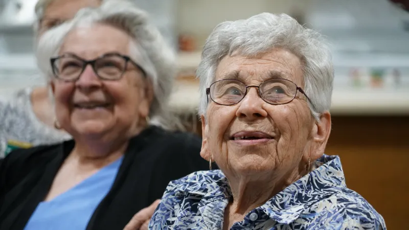 two senior women smiling