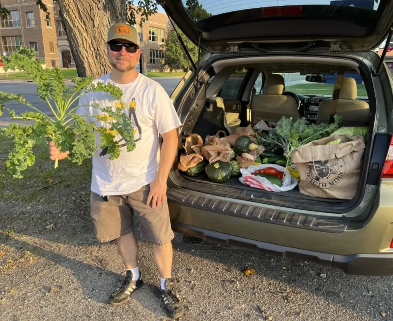 man with fresh vegetables to donate to food pantry
