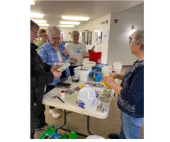A group of senior citizens planting seeds