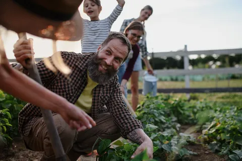 Happy farmers or gardeners working outdoors in garden