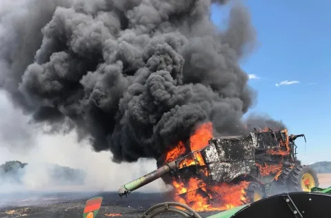 combine on fire in field