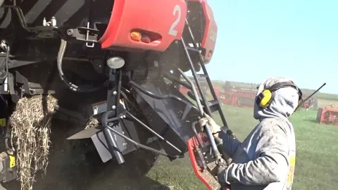 Someone blowing off dust from a combine.