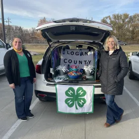 Logan County 4-H Council Members standing next to their Trunk-or-Treat display