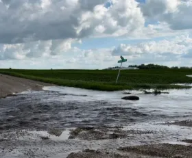 flash flood of water washing out a dirt road