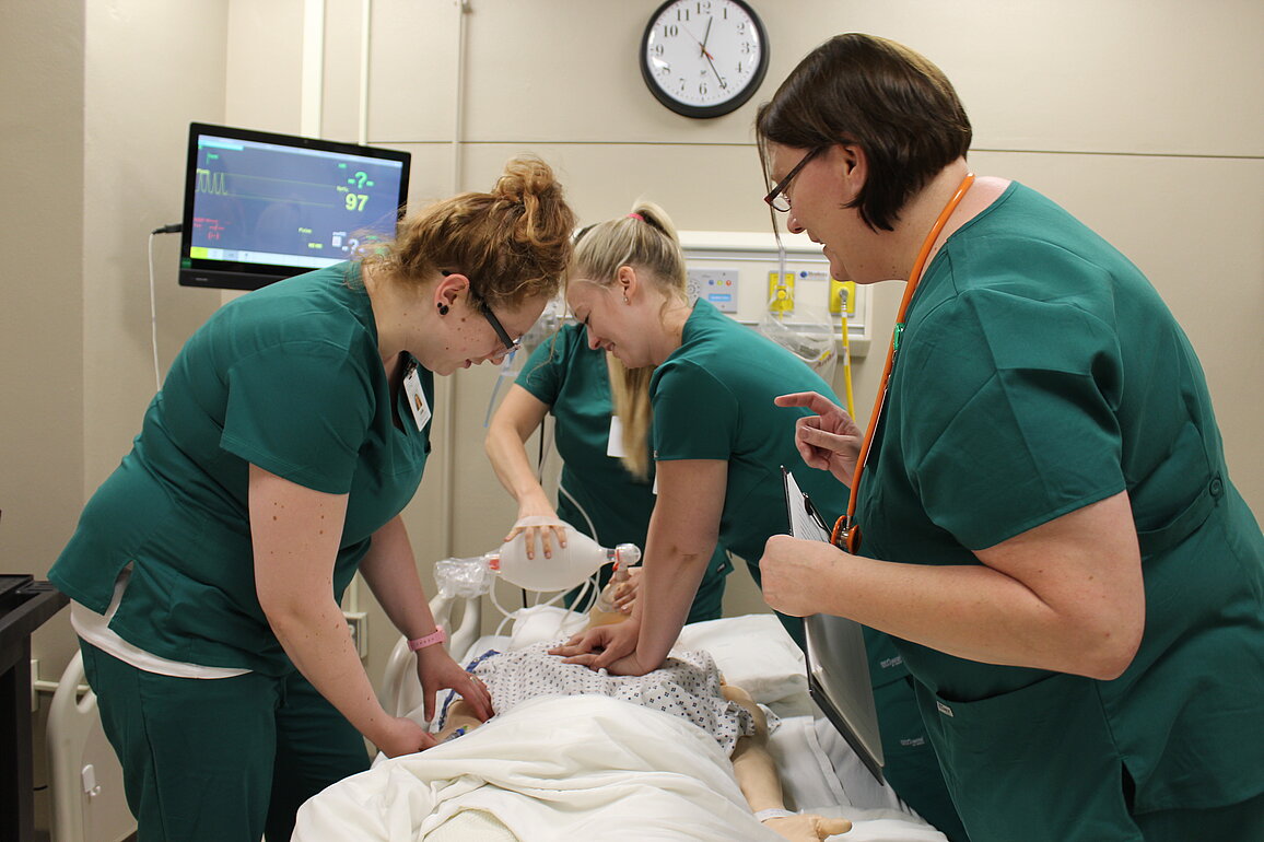 image of students around hospital bed