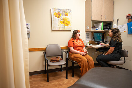 Image of student and nurse sitting in a exam room