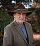 Prof. Tom Isern, in a cowboy hat and brown jacket
