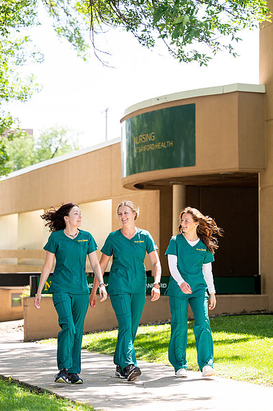Three NDSU Nursing at Sanford Health Bismarck students walking in a group outside their school