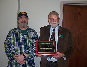 Picture of Dr Slator and Dr Nygard with his award.