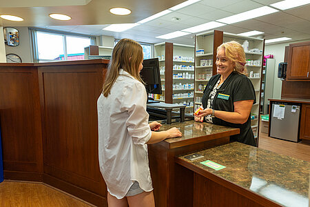 Student picking up prescriptions from the Student Health Service Pharmacy