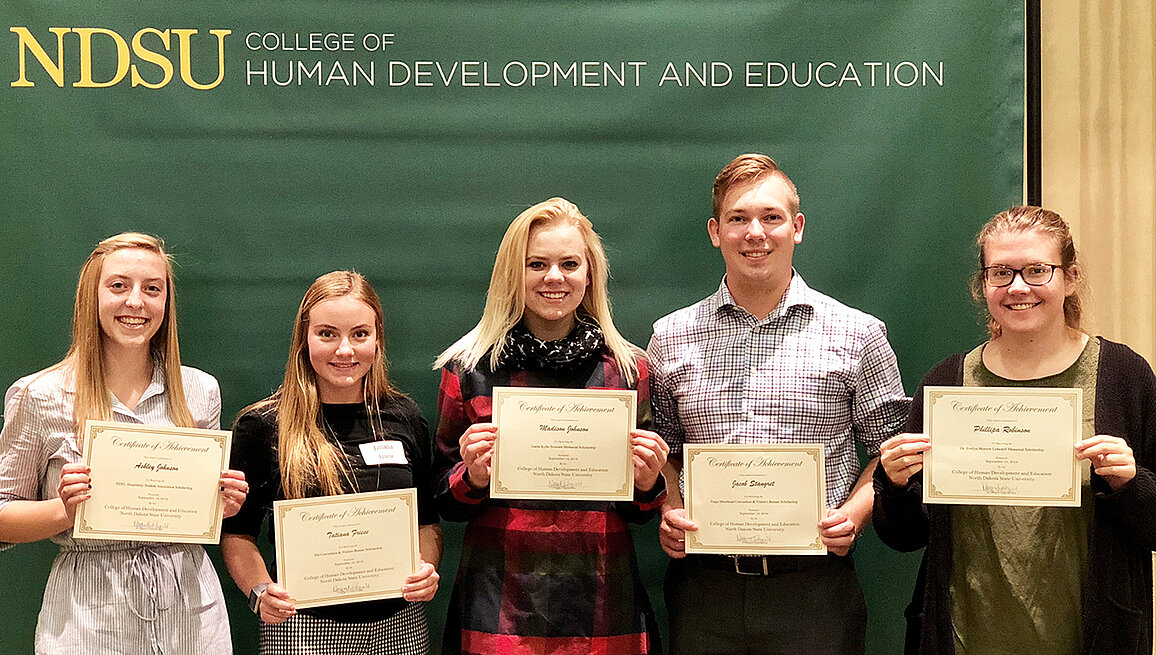 Photo of students with achievement certifcates