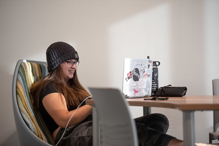 Student connecting to class online using a laptop