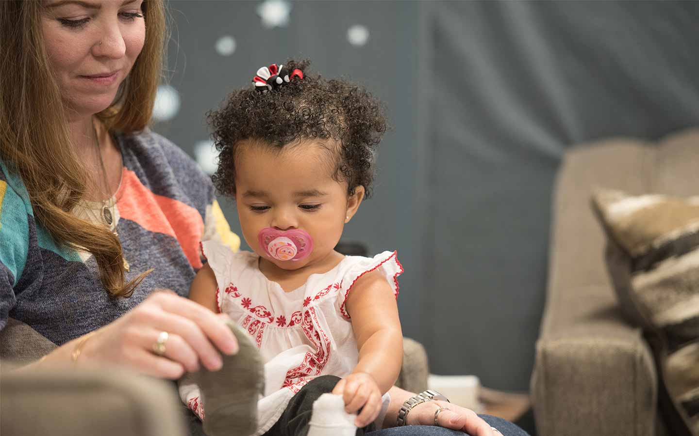 Female graduate student holding child