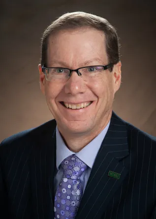 Headshot of Menard Family Director, John Bitzan, Ph.D.