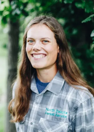 A woman with long brown hair smiles