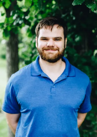 A man with a beard smiles