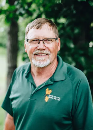 A man with glasses and a goatee smiles