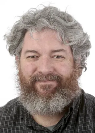 John Lamb smiling confidently at camera.