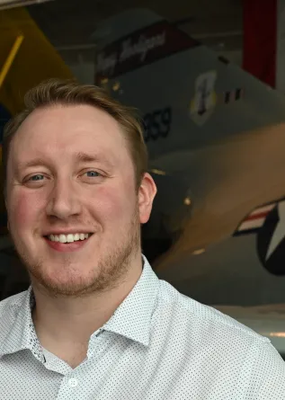 Max is smiling at the camera.