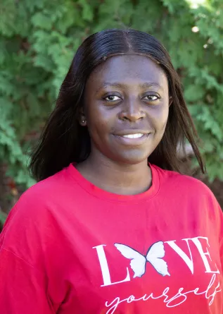 Elizabeth is smiling at the camera.