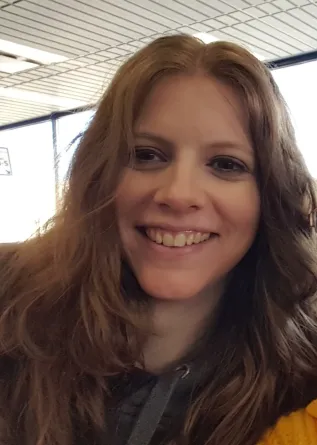 Laura is smiling at the camera.