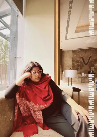 Indrani smiling at the camera.