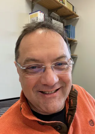 Angel Ugrinov smiling confidently at the camera