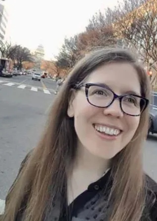 Lisa Arnold smiling off to the right of camera.