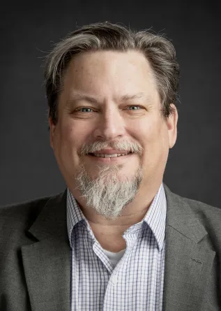 Dr. Clayton Hilmert confidently staring at the camera