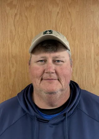Headshot of a man in a hoodie and baseball cap