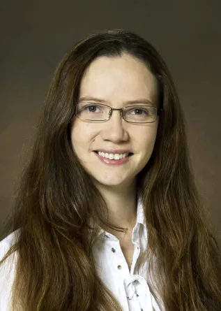 Pam is smiling for the camera