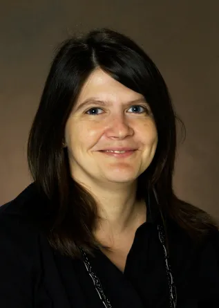 Mila Kryjevskaia smiling confidently at camera.