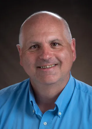 Greg Cook smiling confidently at camera