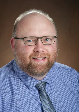 Stuart Haring smiling confidently at the camera