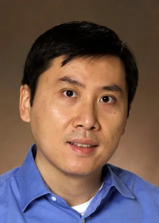 Pinjing Zhao smiling confidently at the camera