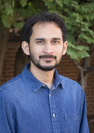 Motasim smiling at the camera