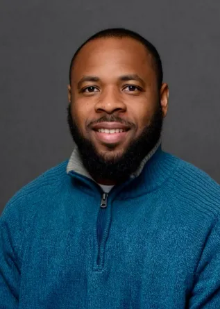 Dadzie smiling at the camera