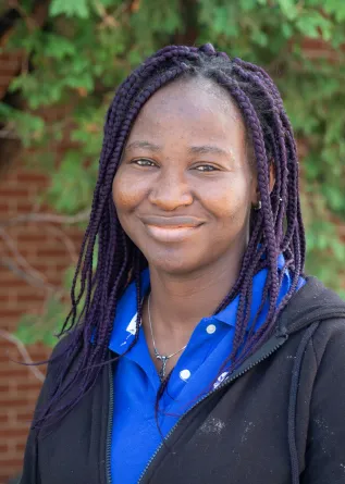 Funmi smiling at the camera