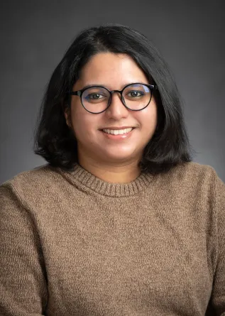 Zakia smiling at the camera