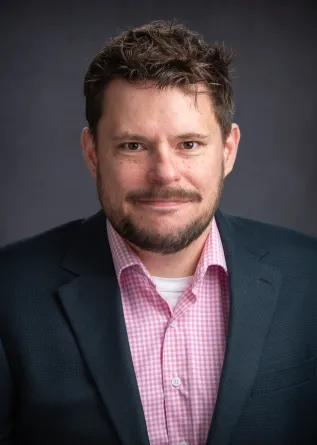 Justin smiling at the camera