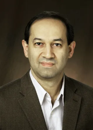 Bakhtiyor Rasulev smiling confidently at the camera